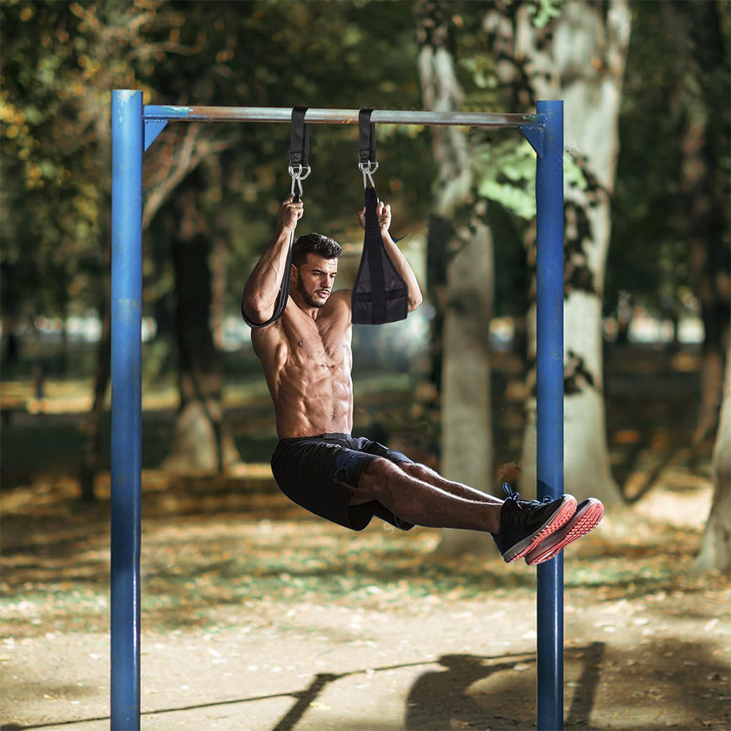 AlephNeta CoreStraps used by a fit man performing abdominal exercises outdoors.